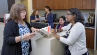 Social worker and nurse speak to each other in the Department of Radiation Oncology.